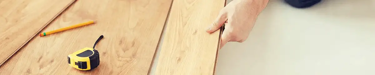 A professional installing wood flooring in Pittsburgh, PA