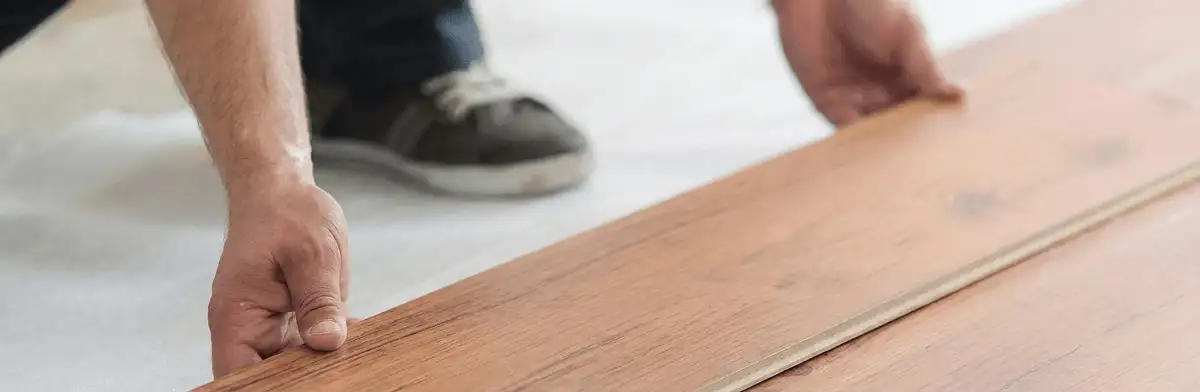 A professional installing laminate flooring in Pittsburgh, PA