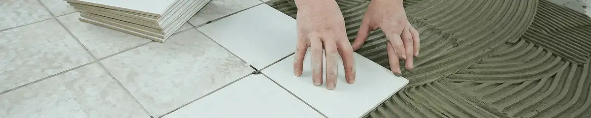 Professional installing white tile floors in Pittsburgh, PA