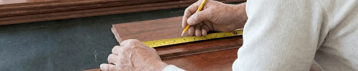 A professional installing wood flooring in Pittsburgh, PA